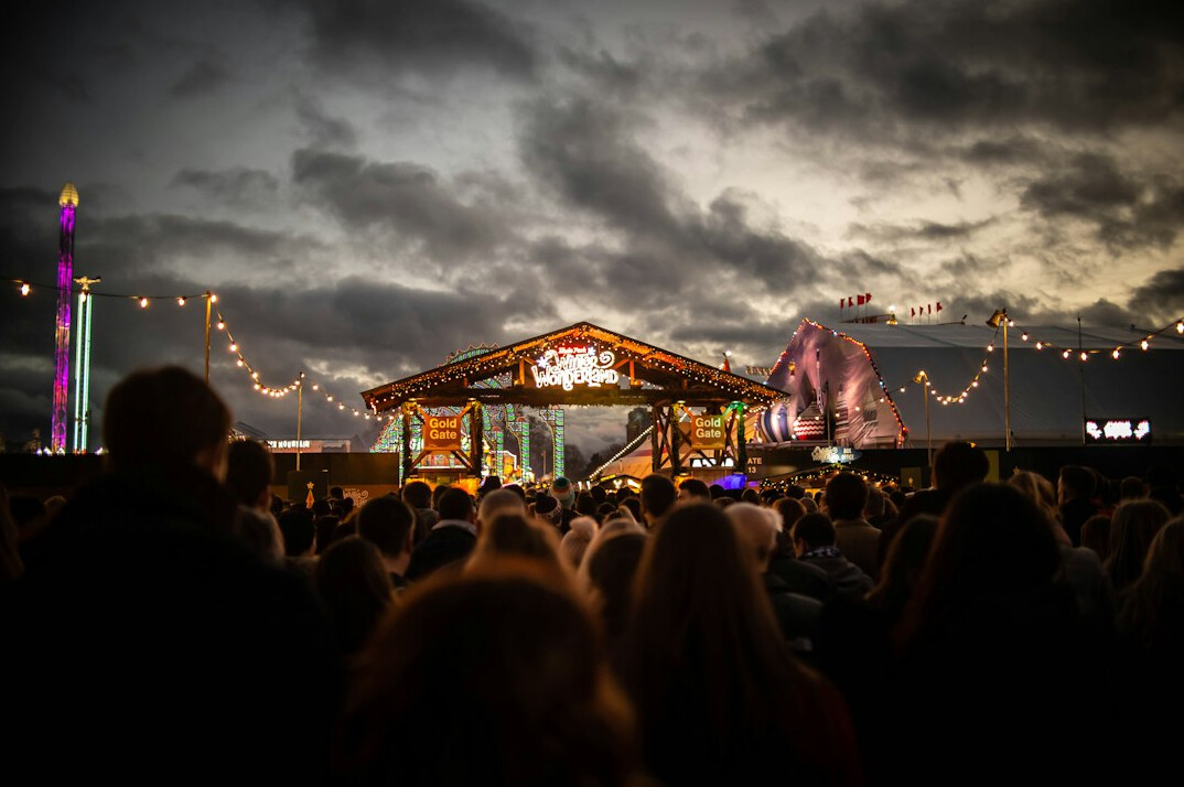 Festival stage with bright lights and an audience at night