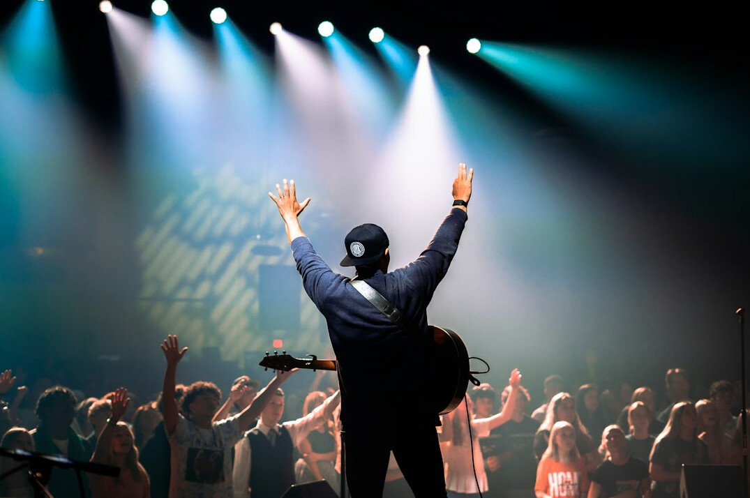 Live concert with stage lights and an excited crowd
