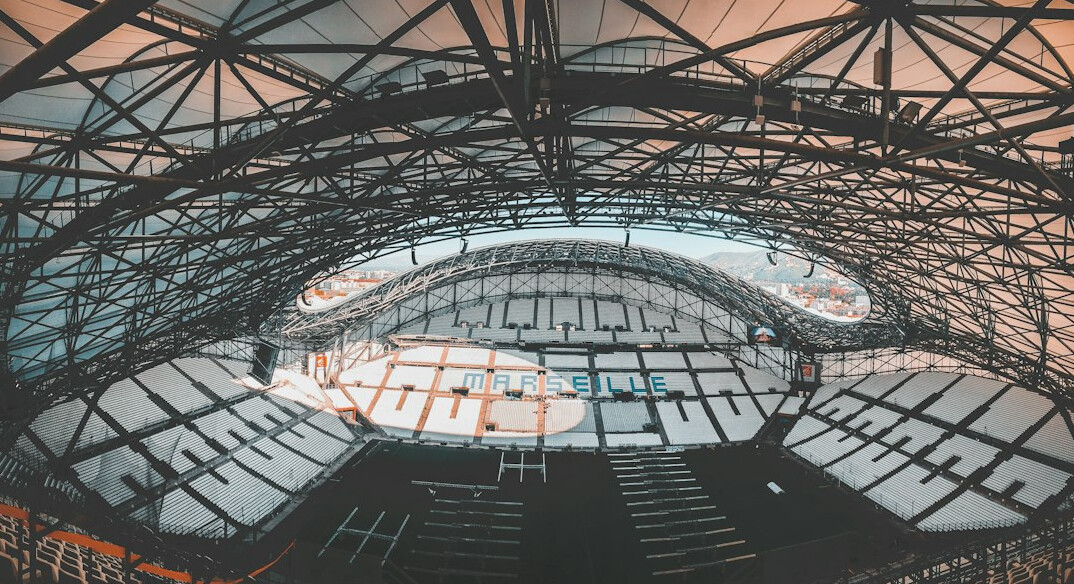 Football stadium full of fans under floodlights