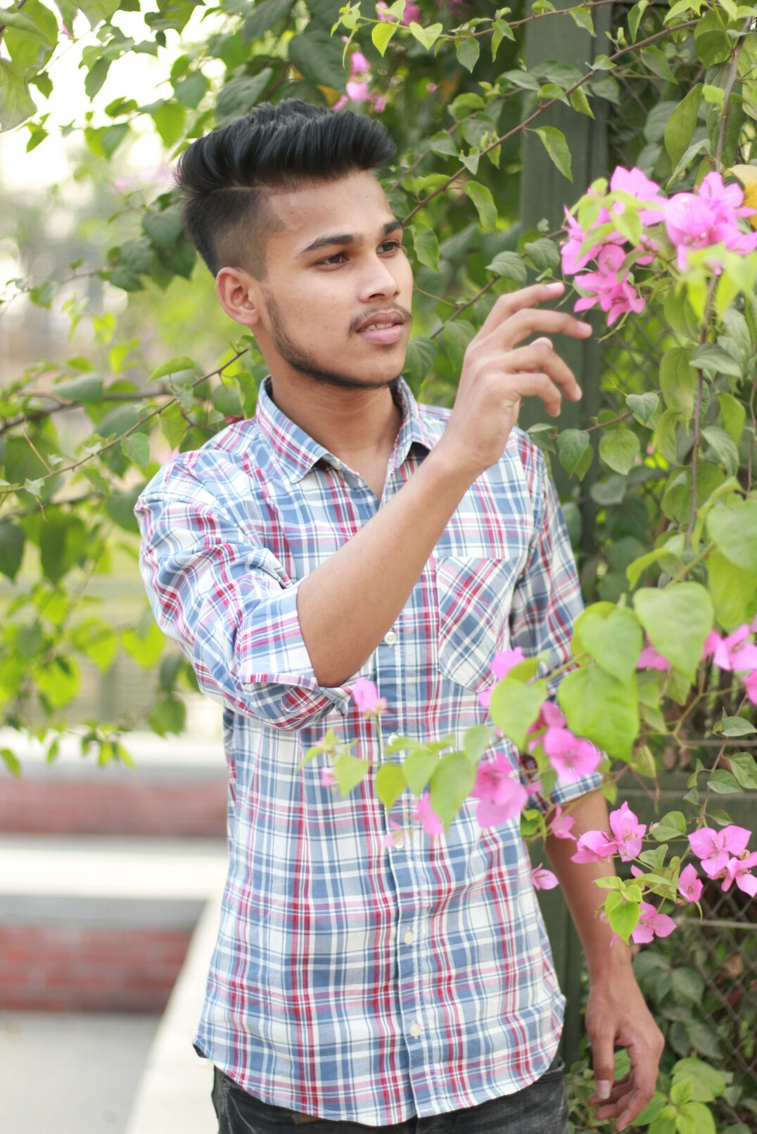 Portrait of a young man with short hair in a casual shirt